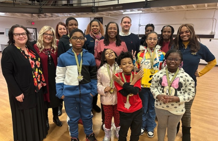 Spelling bee participants and teachers posing for the camera
